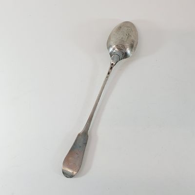 a spoon that is sitting on a white table