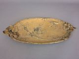 an image of a gold plate with flowers and leaves on it