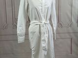 a picture of a white shirt dress on a mannequin stand
