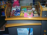 a cash counter with a lot of items on it