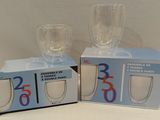 two empty wine glasses sitting on top of a box next to each other