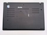 a black laptop with a small battery on top of it
