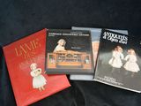 three children ' s books are sitting on a black cloth