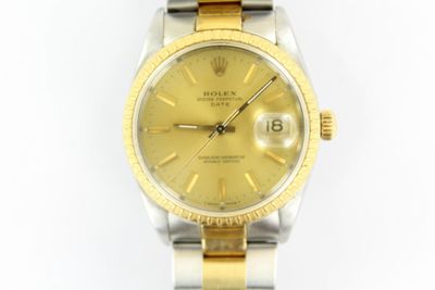 an image of a gold and silver rolex watch on a white background