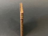 a close up of a wooden stick with writing on it
