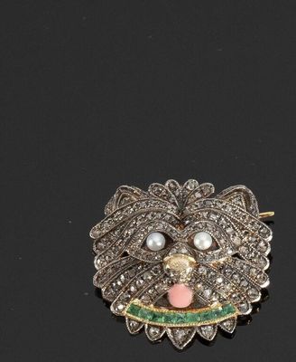 une image représentant une broche ornée de perles et d'une tête de chien