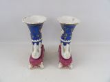 two blue and white vases sitting on top of each other