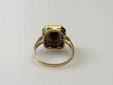 a close up of a gold ring on a white surface
