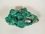 green crystals on a white surface with a white background