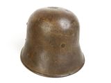 an old metal helmet on a white surface with a white background