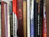 many books that are on a shelf in a book case