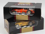 two boxed boxes with a red and gold model of a race car
