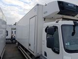 a white truck that is parked next to another truck