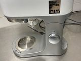 a white mixer sitting on top of a kitchen counter