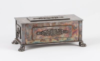 a small metal box with a decorative design on it