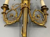 an image of a gold colored chandelier with three candles