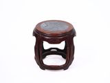 a small wooden stool with a marble top on a white surface