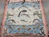 a blanket with a picture of dolphins and other animals on it