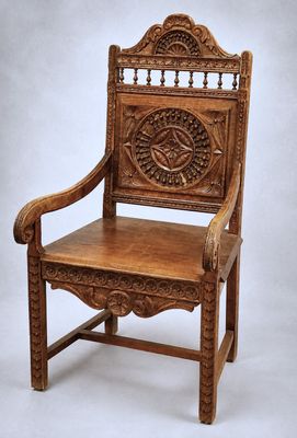 an old wooden chair with a carved back and seat on a white background