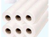 four rolls of white paper are stacked on top of each other