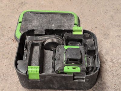 a black and green tool box with tools in it