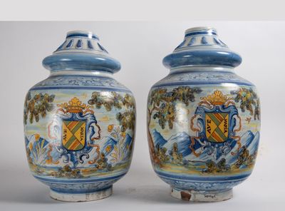 pair of blue and white vases with a coat of arms on them