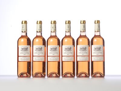 six bottles of wine are lined up on a table