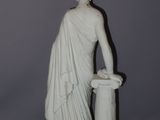 marble statue of a man with a bucket of water in his hand