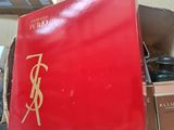 a red box with a gold ysl logo on it