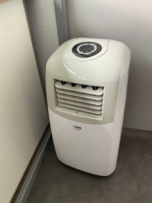 un petit climatiseur dans un coin de la pièce