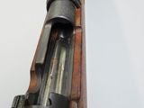 an old rifle is sitting on a white surface with a white background