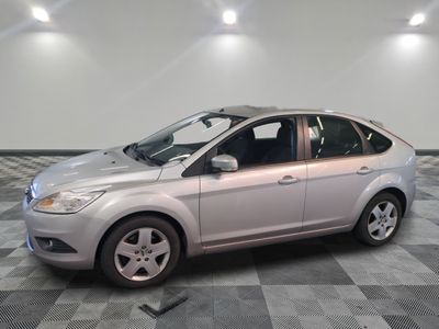 a picture of a silver ford focus parked in a garage