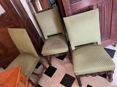 two green chairs sitting next to each other on a tiled floor