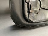 a close up of a black purse with a metal buckle