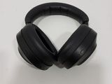 an image of a pair of black headphones sitting on top of a table