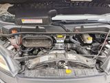 the engine of a car with its hood open and the hood down