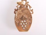 an image of a gold locke with pearls on a white background