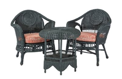two wicker chairs and a table with cushions on a white background