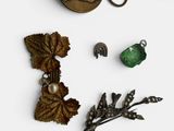 several different pieces of jewelry are displayed on a white surface