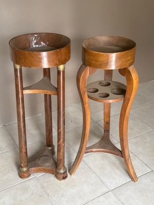 two wooden tables that are sitting on a tile floor