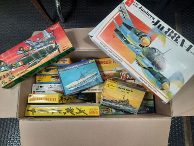 a box full of assorted toys and books on the floor
