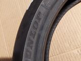 tire tread of a car on a cardboard box with a box in the background
