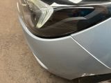 a close up of a car ' s headlight with a sticker on it