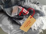 a scarf with a tag on it and a pair of glasses
