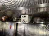 many plates and pans on the shelf in the kitchen