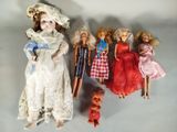 many dolls that are lined up together on a table