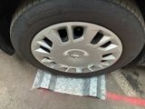 a close up of a tire on the ground next to a piece of metal