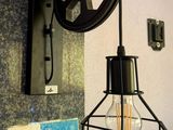 a light that is hanging on the wall next to a lamp