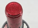 a bottle of wine that has a red label on it