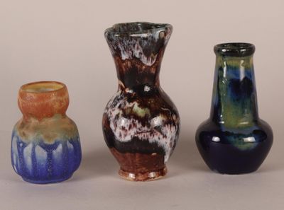 three vases sitting next to each other on a table